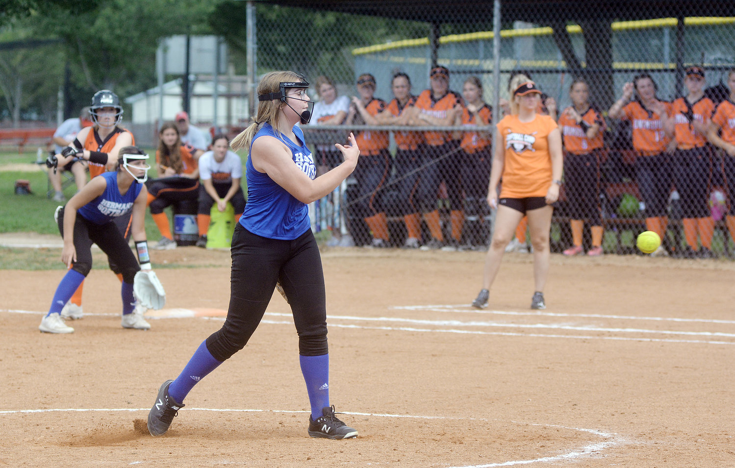 Madison Holliday (center) lets a pitch fly with the Owensville Dutchgirl dugout in the background during preseason jamboree action at Nelson Hart Park in St. James Saturday morning.